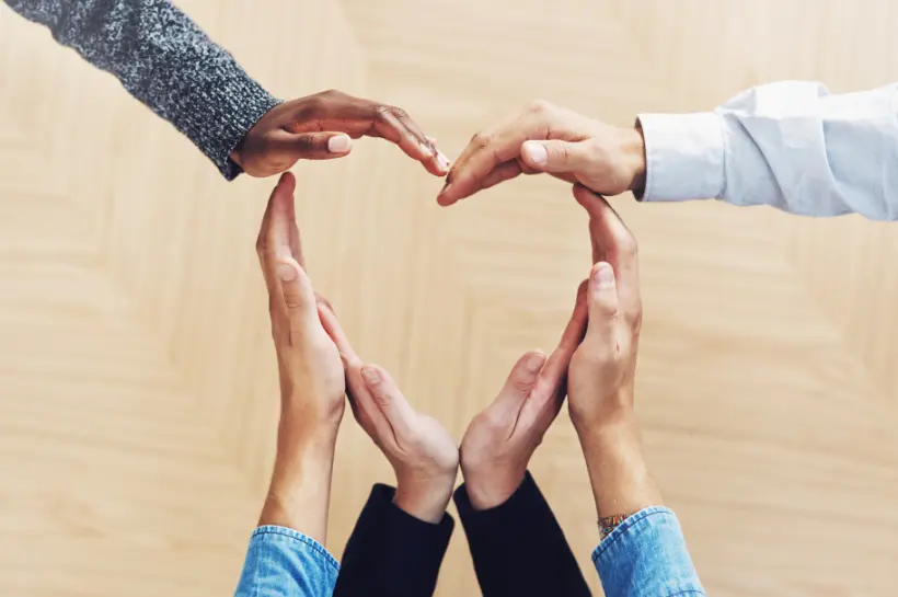 a group of people making a heart shape with their hands